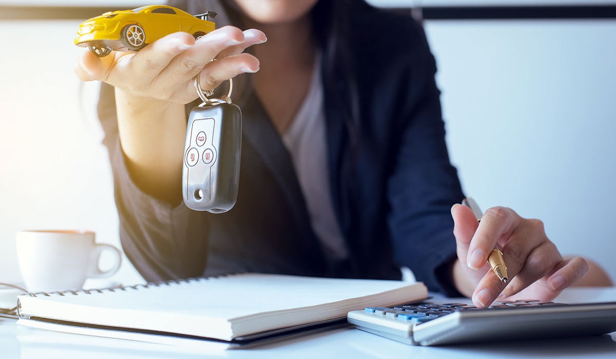 Woman With Car Key and Calculator