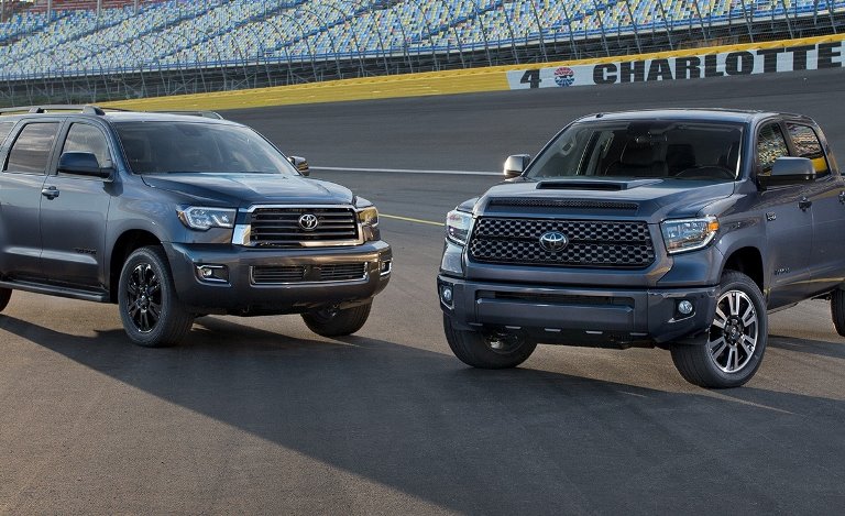 Image of two Toyota Sequoia SUVs parked next to each other.