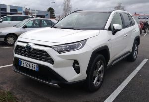 a white toyota rav4 is parked 