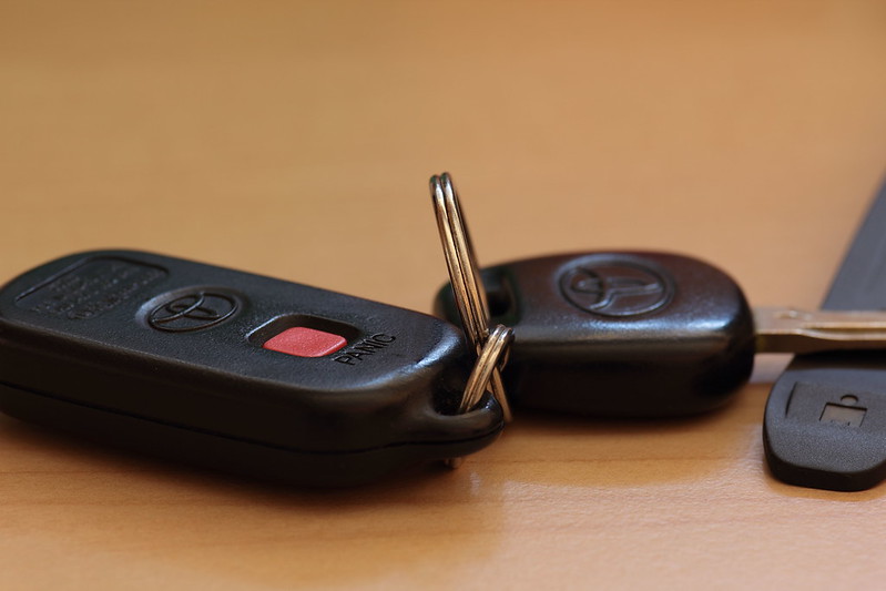 Two Toyota key fobs resting on a table.