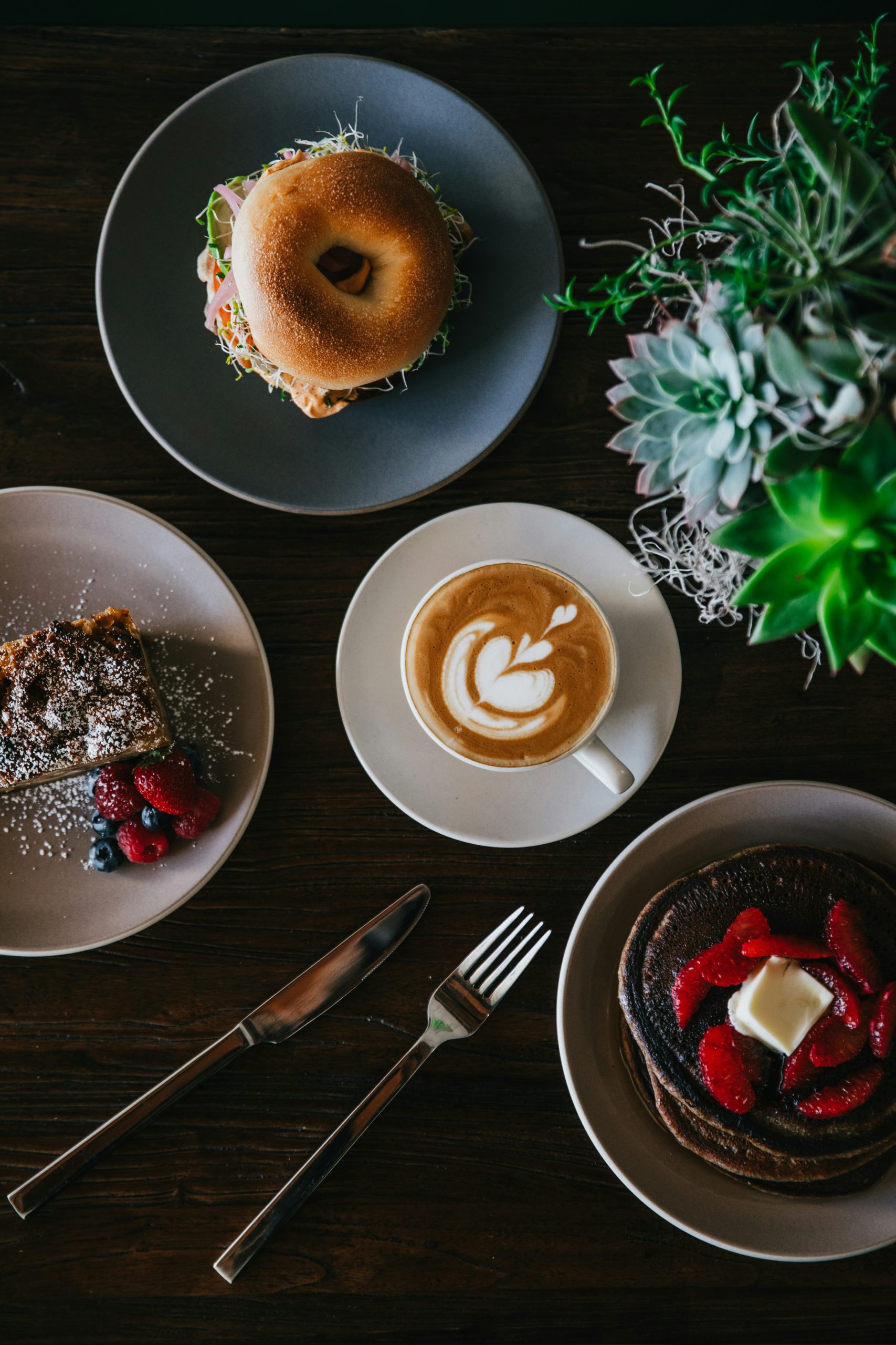 coffee with latte art surrounded by sweets
